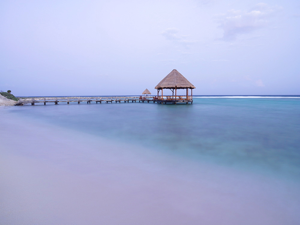 Pier with palapa jutting out into the water from the beach, Mayan Riviera, Akumal, Yucatan, Quintana Roo, Mexico, North America