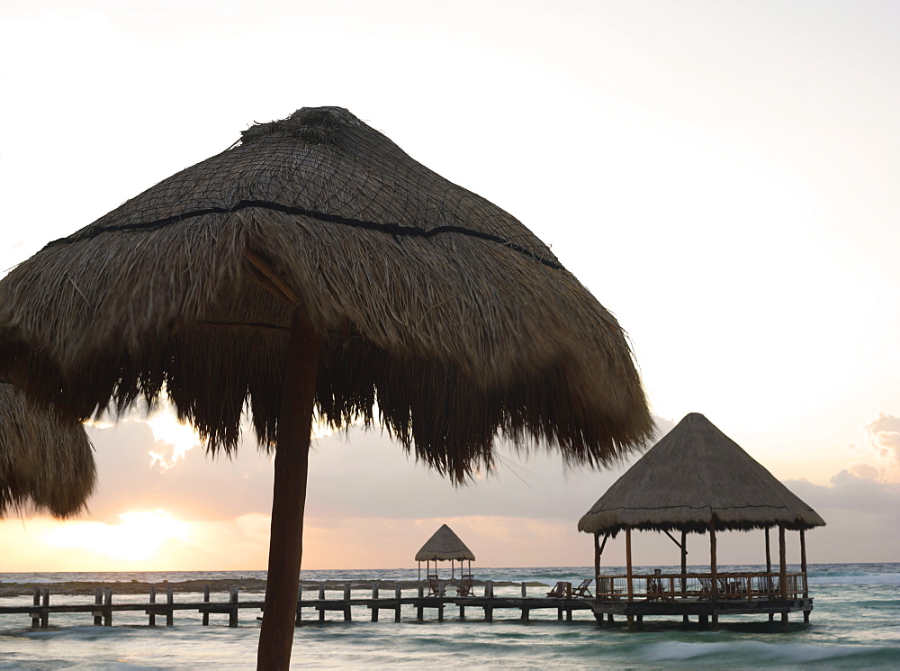 Pier with palapa jutting out into the water from the beach at sunrise, Mayan Riviera, Akumal, Yucatan, Quintana Roo, Mexico, North America