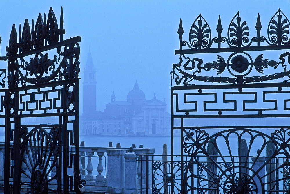 View of San Giorgio Maggiore from The Giardinetti Reali (royal gardens) framed through an iron gate, Venice, UNESCO World Heritage Site, Veneto, Italy, Europe