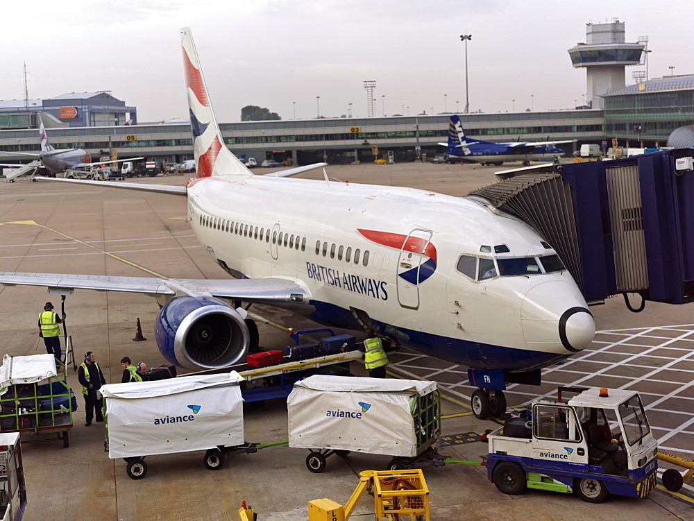 British Airway plane at terminal with baggage being unloaded, Heathrow Airport, London, England, United Kingdom, Europe