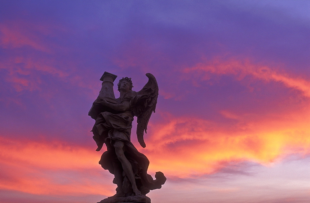 Statue of an angel on Ponte Sant Angelo with colorful sky, Rome, Lazio, Italy, Europe