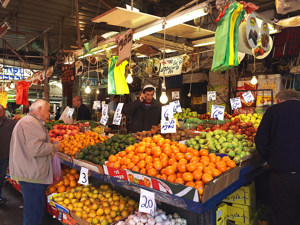 Fresh fruit stand and shoppers, Carmel Market, Tel Aviv, Israel, Middle East