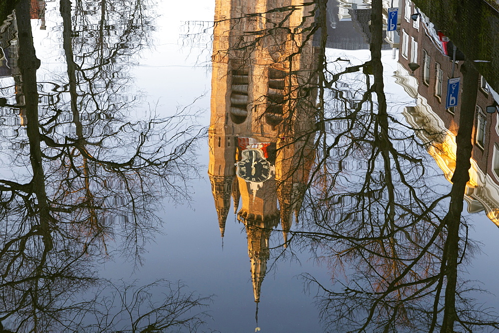 The leaning tower of the Oude Kerk (Oude Jan) (Scheve Jan) reflected in the Oude Delft canal in Delft, South Holland, The Netherlands, Europe