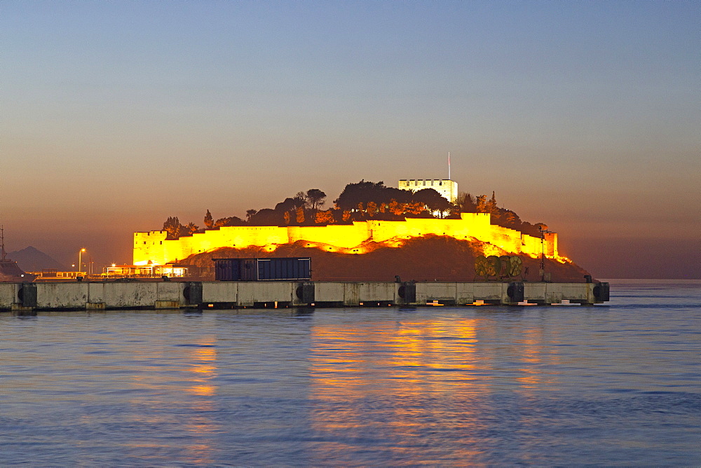 The Byzantine-era fortress, illuminated at dusk, on Guvercin Ada (Pigeon Island), on the Aegean coast, in Kusadasi, Turkey, Asia Minor, Eurasia