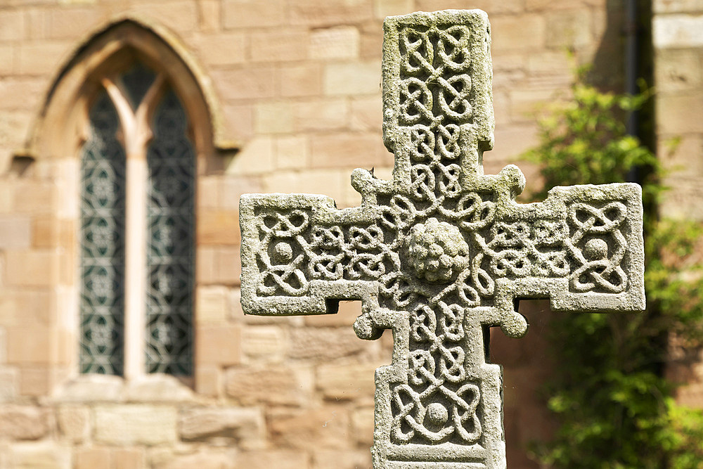 Anglo-Saxon Cross in the churchyard of St. Aidan's Church, a 12th century place of worship and a key location in the introduction of Christianity during Anglo-Saxon times, Bamburgh, Northumberland, England, United Kingdom, Europe