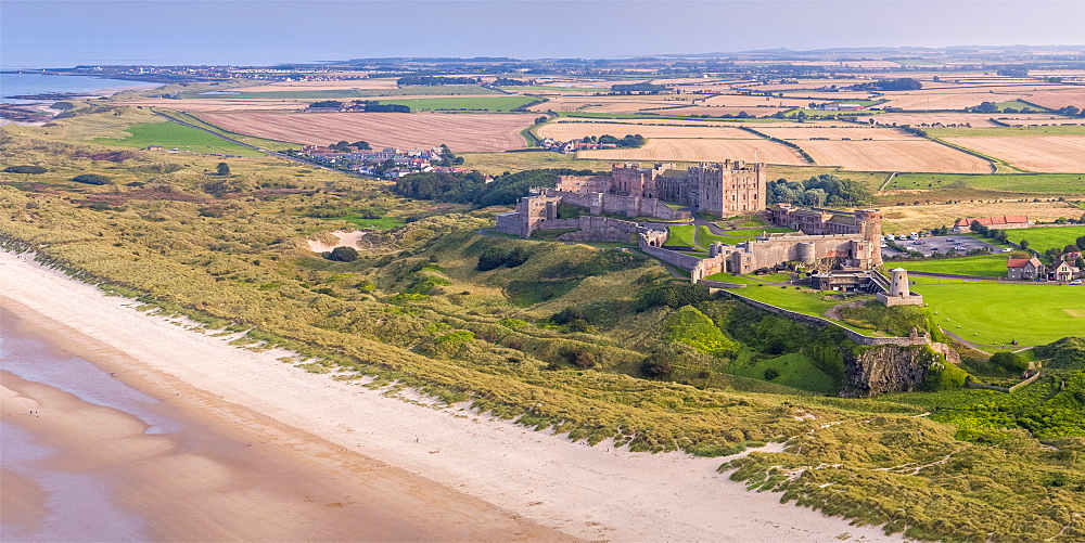 Aerial view by drone of Bamburgh Castle, Bamburgh, Northumberland, England, United Kingdom, Europe