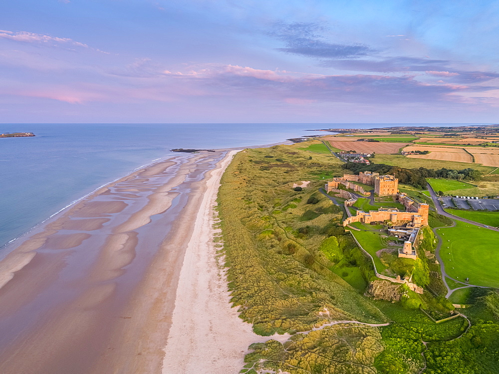 Aerial view by drone of Bamburgh Castle, Bamburgh, Northumberland, England, United Kingdom, Europe