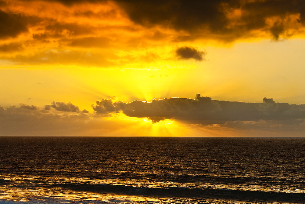 Sunset lighting the clouds offshore from this village on the north west coast, El Cotillo, Fuerteventura, Canary Islands, Spain, Atlantic, Europe