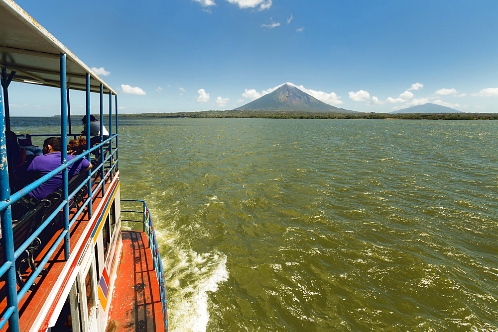 Ferry and the twin peaks of Omotepe Island's volcanoes Concepcion on left and Maderas, Isla Omotepe, Lake Nicaragua, Nicaragua, Central America