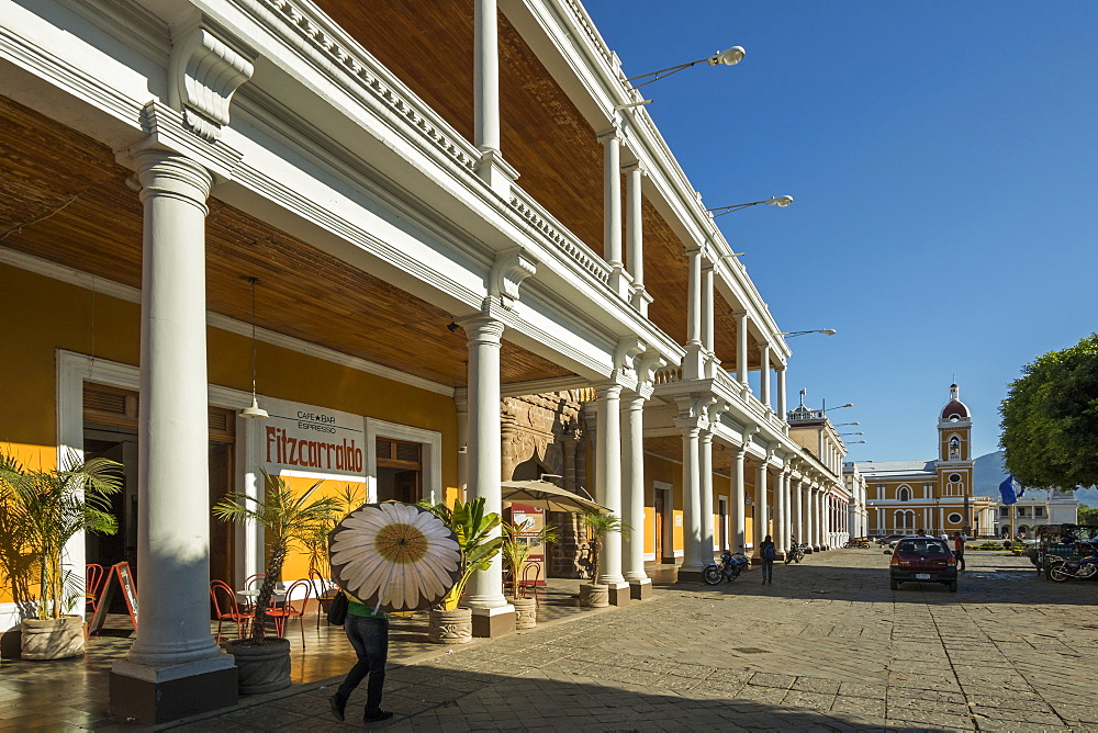 View along colonnades of Plaza de la Independencia to Granada Cathedral in the heart of this historic city, Granada, Nicaragua, Central America