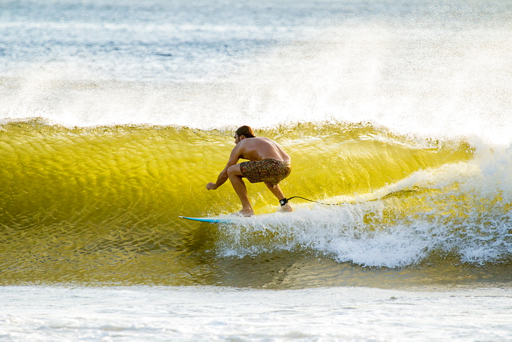 Surfer in barrel of this famous shore break wave near San Juan del Sur, Playa Maderas Beach, San Juan del Sur, Rivas, Nicaragua, Central America