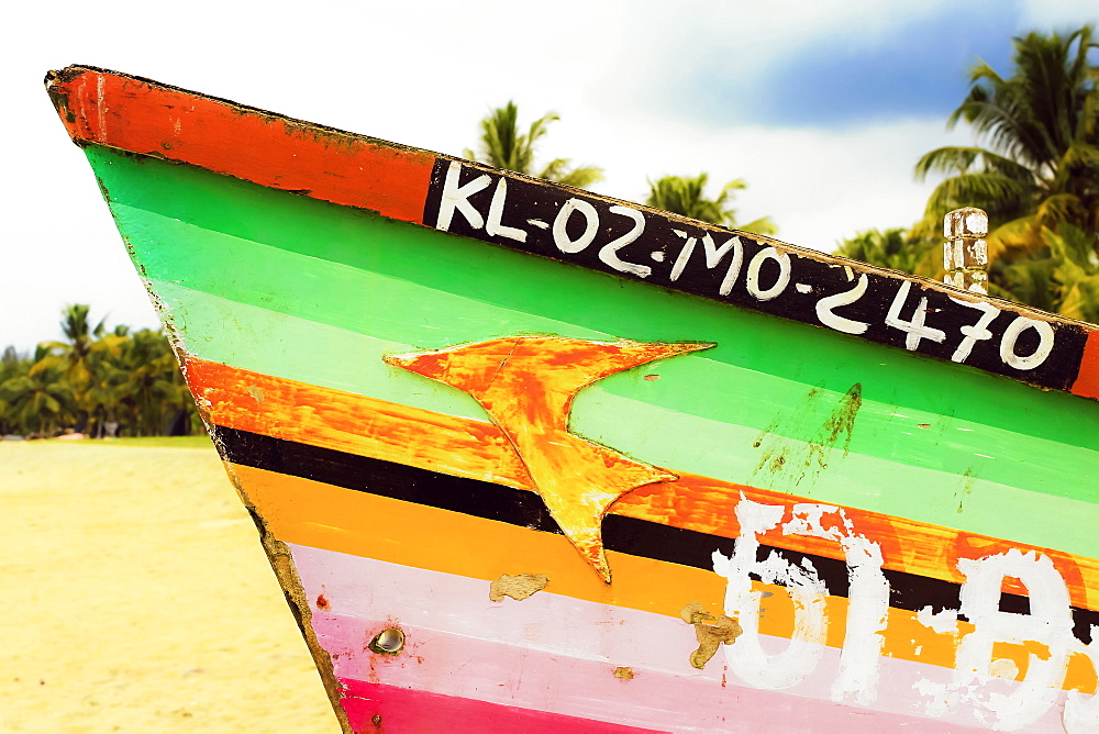 Prow of colourfully decorated fishing boat on popular Marari Beach, Mararikulam, Alappuzha (Alleppey), Kerala, India, Asia