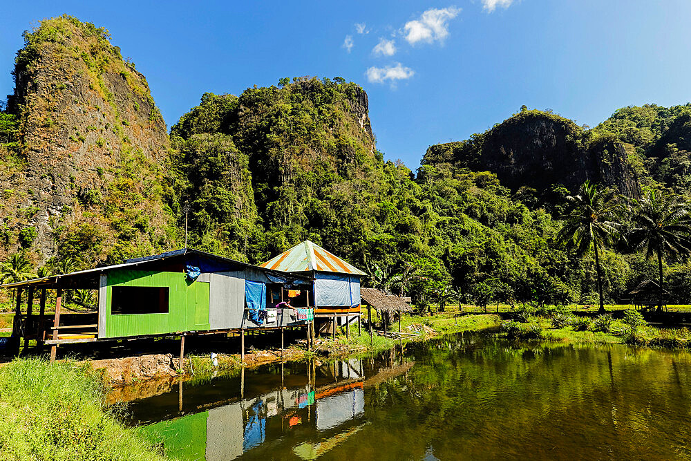 Fish pond and limestone outcrops at Rammang village, karst region, Rammang-Rammang, Maros, South Sulawesi, Indonesia, Southeast Asia, Asia