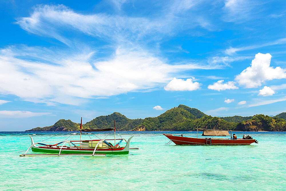 Outrigger canoe and tour boat off Mahoro Island, Pahepa Island beyond, Mahoro, Siau, Sangihe Archipelago, North Sulawesi, Indonesia, Southeast Asia, Asia