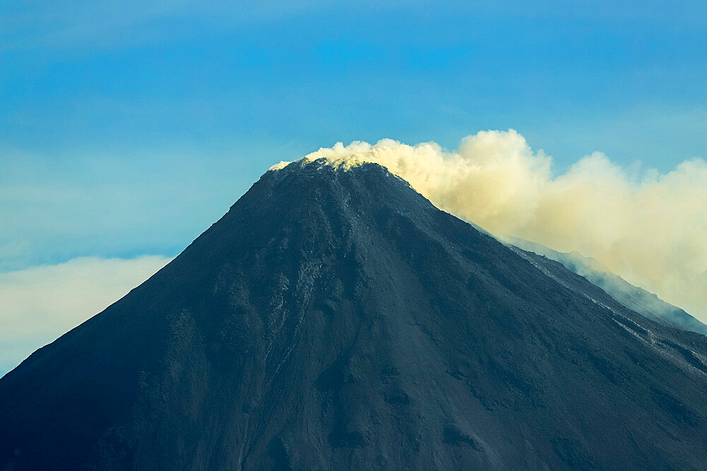 Sulphur smoke atop this active 1784m Pacific Ring of Fire volcano. Mount Karangetang, Siau, Sangihe Islands, Sulawesi, Indonesia