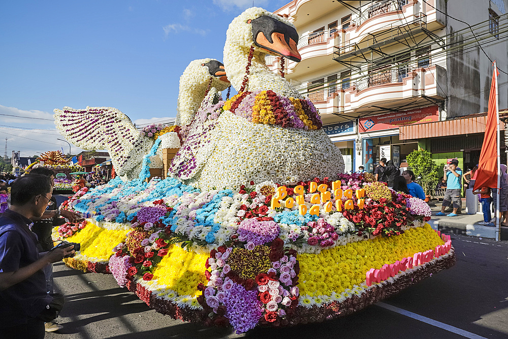 Float with large flower swans at the annual Tomohon International Flower Festival parade in city that is the heart of national floriculture, Tomohon, North Sulawesi, Indonesia, Southeast Asia, Asia