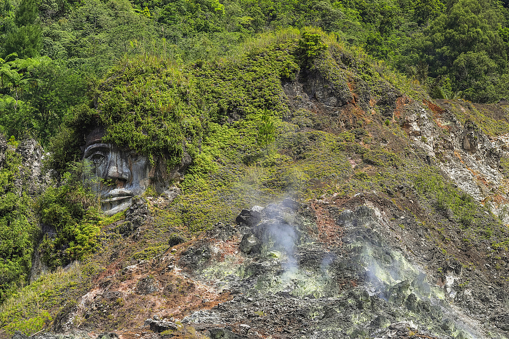 Large carved face at Bukit Kasih, a volcanic tourist park with fumarole fields, a world peace themed tower and worship houses of five major religions, Bukit Kasih, Minahasa, North Sulawesi, Indonesia, Southeast Asia, Asia