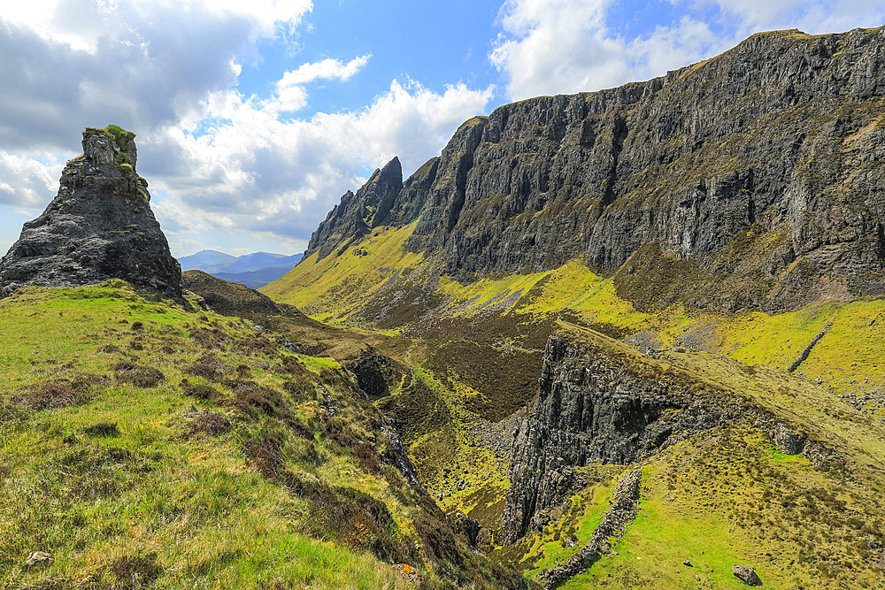 Towering cliffs of basalt lava over Jurassic sediments at the Quiraing, a famous hike and scenic attraction in the far north east of the island, Quiraing, Staffin, Skye, Inner Hebrides, Scotland, United Kingdom, Europe