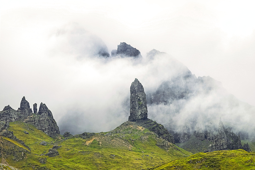 Skye's best known landmark, The Old Man of Storr, the 55m volcanic plug spire in swirling clouds below the Trotternish Ridge in the North East, The Old Man of Storr, Trotternish, Portree, Skye, Inner Hebrides, Scotland, United Kingdom, Europe