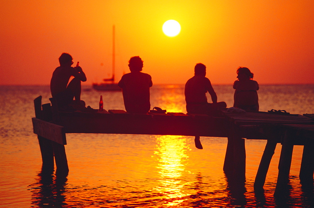 Tourists enjoying the sunset, Roatan, largest of the Bay Islands, Honduras, Caribbean Sea, Central America