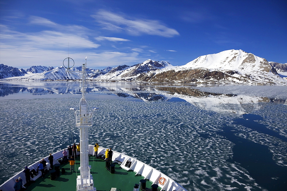 Tourists on board Arctic polar exploration cruise ship near Monaco glacier in summer, Liefdefjorden, Spitzbergen, Svalbard, Norway, Scandinavia, Europe