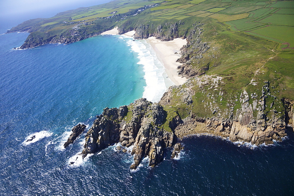 Aerial photo of Treen Cliff and Porthcurno beach looking west to the Minnack Theatre, West Penwith, Cornwall, England, United Kingdom, Europe