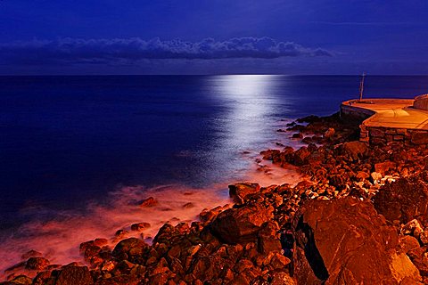 sea and the rocky coast in the moonshine, Camara de Lobos, Madeira, Portugal