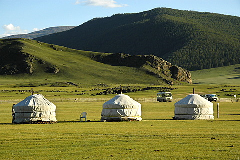 Three yurts ger in the steppe in front of a forested mountain range Orkhon waterfall Mongolia