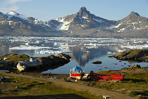 Old colourful boats at the shore Ammassalik Fjord Eastgreenland