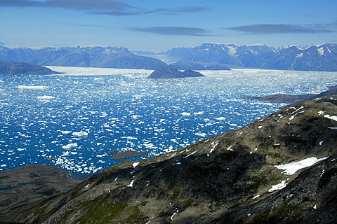 Wide open view over rocks to icebergs glaciers and mountains Sermilik Fjord Eastgreenland