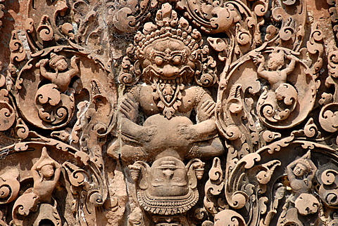 Tantric stone relief demon and apsara temple Banteay Srei Angkor Siem Reap Cambodia