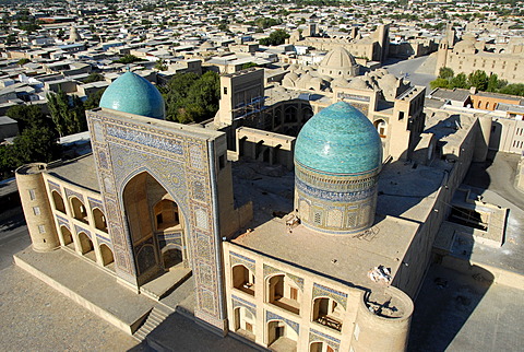 View over the blue cupolas of Mir-i Arab Madrasah and roofs of the city from minaret Kalon Bukhara Uzbekistan