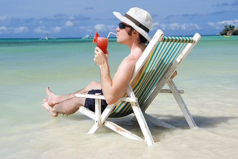 Man with cocktail at seashore