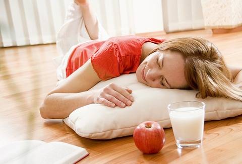 Woman relaxing on the parquet floor