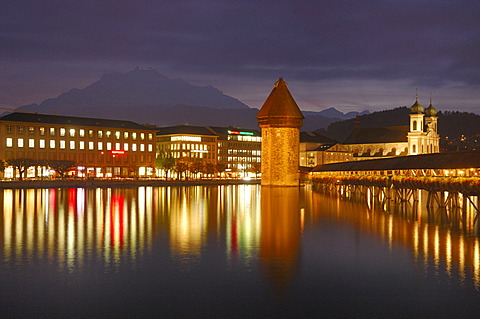 Kapellbruecke mit water tower at dusk, Lucerne, Switzerland