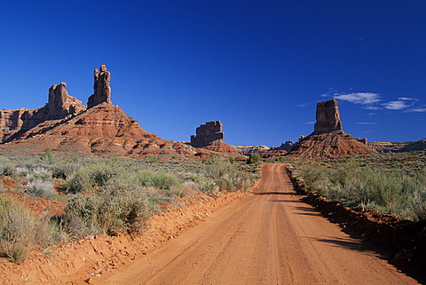 Dirtroad between sandstone buttes in Valley Of The Gods Utah USA