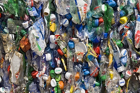 Plastic bottles, compressed into a large bale and ready for recycling