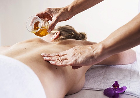 Young woman receiving an oil massage