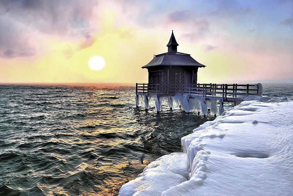 Bathhouse on pier with icicle in winter at sunrise, Lake Neuchâtel, Gorgier, Canton Neuchâtel, Switzerland, Europe