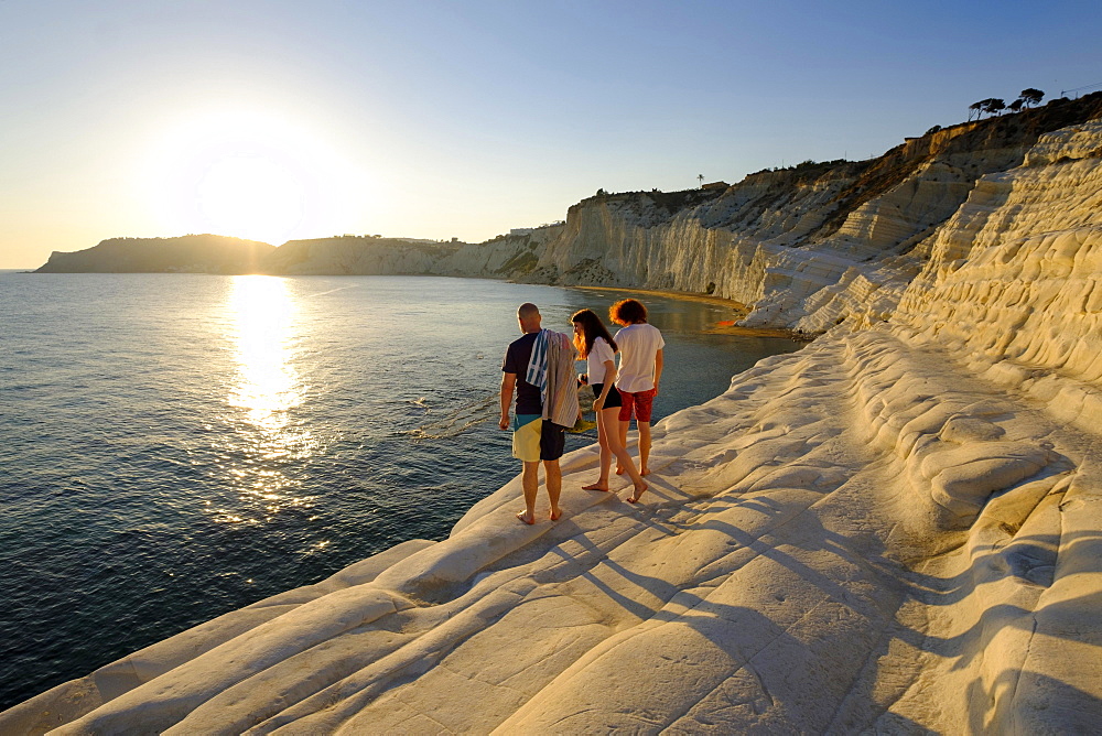 Tourists during sunset, rocky coast of Scala dei Turchi, limestone rocks, Realmonte, Province of Agrigento, Sicily, Italy, Europe