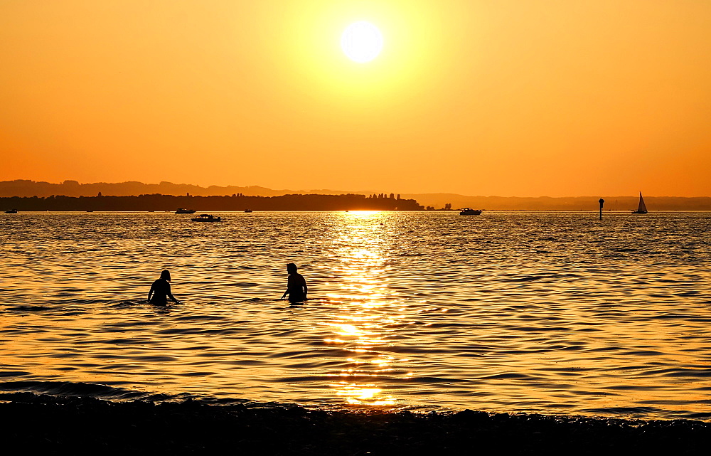 Bathers in Lake Constance, sunset, Rohrspitz, Vorarlberg, Austria, Europe