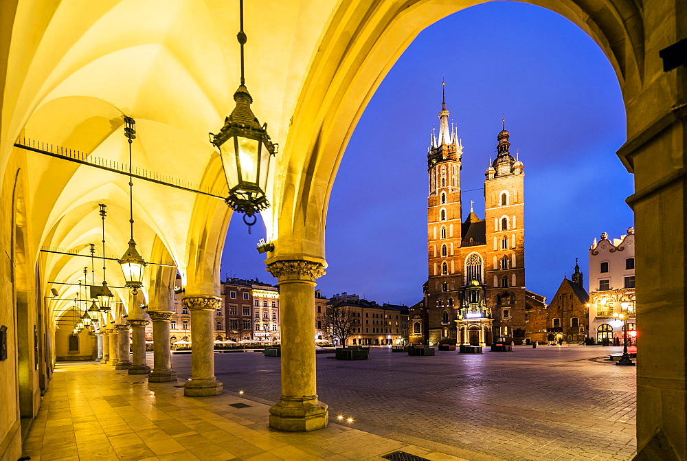 Illuminated market square at dawn, Krakow, Poland, Europe