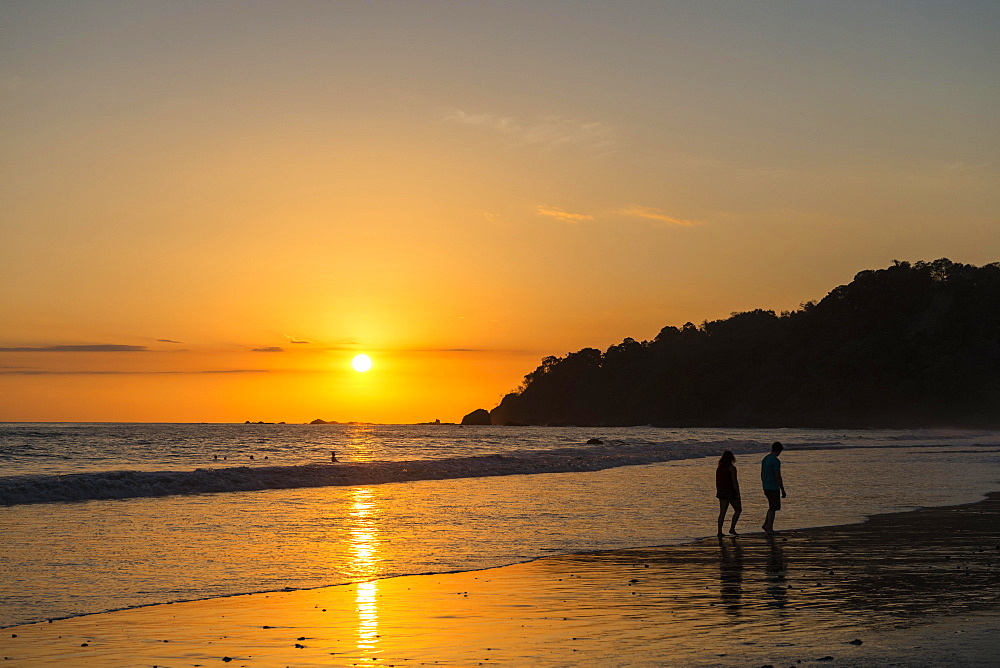 Man and woman strolling on the beach, sunset, Playa Espadilla, Manuel Antonio National Park, Costa Rica, Central America