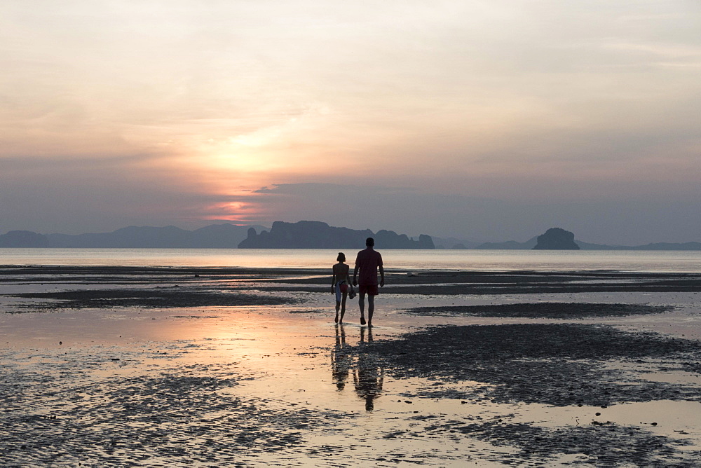 Couple at low tide on the beach at sunset, Tubkaek, Phang Nga Bay, Krabi Province, Thailand, Asia