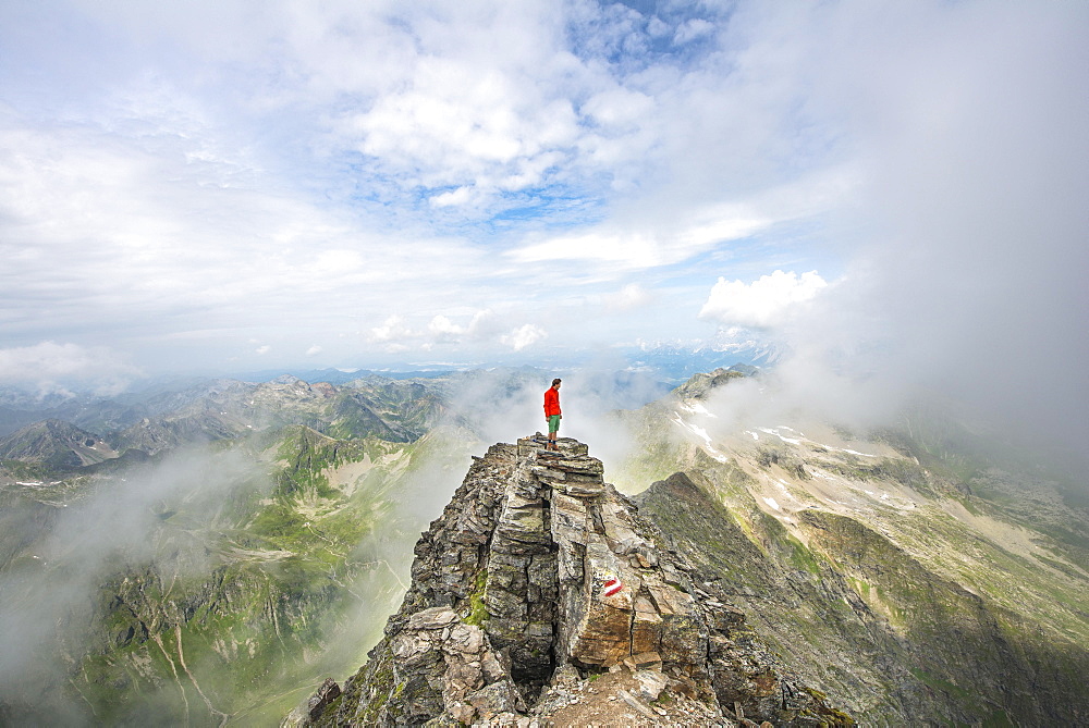 Hiker on the summit of the Hochgolling with rising fog, Schladminger Höhenweg, Schladminger Tauern, Schladming, Steiermark, Austria, Europe