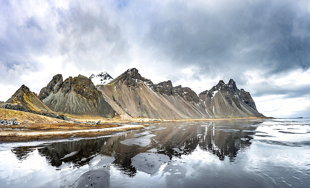 Water reflection, mountains Klifatindur, Eystrahorn and Kambhorn, Stokksnes headland, Klifatindur mountain range, Eastern Region, Iceland, Europe