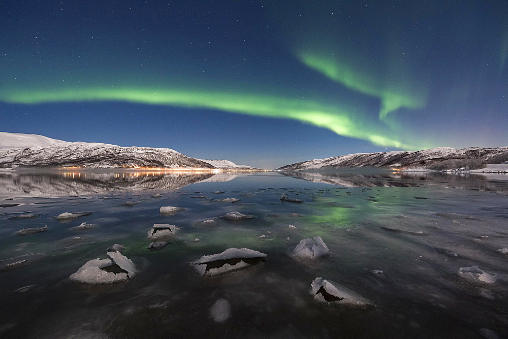 Northern lights over fjord with ice floes, island of Senja, Troms, Norway, Europe