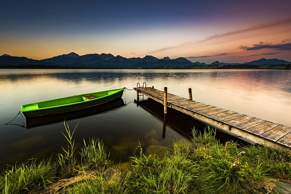 Rowing boat at dock with mountain lake, Allgäu Alps at back, blue hour, Hopfensee, Hopfen am See, Ostallgäu, Bavaria, Germany, Europe