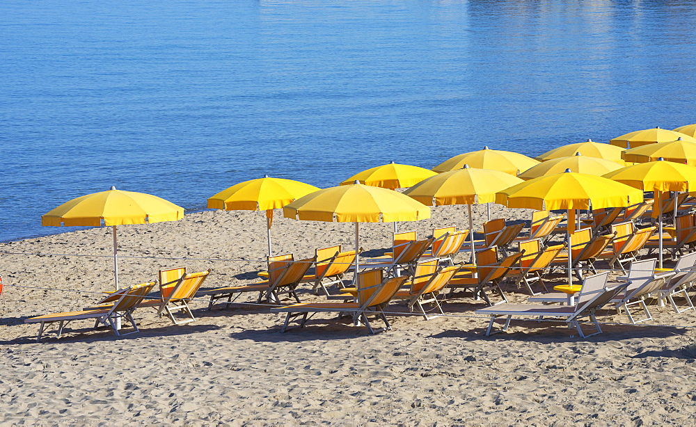 Town beach with yellow parasols, Cefalu, Sicily, Italy, Europe