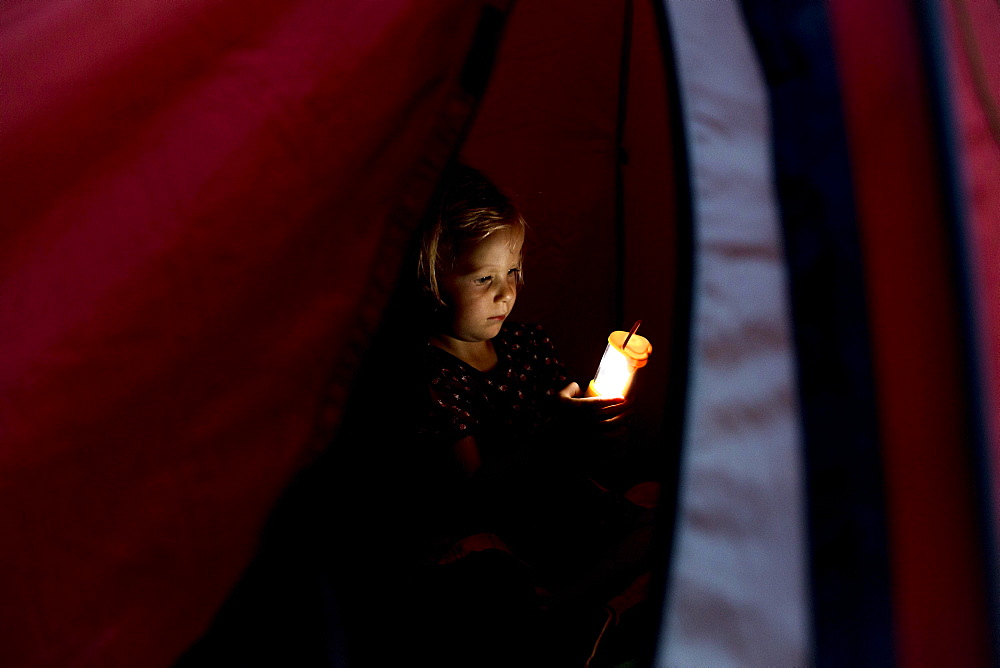 Toddler, three years old, in tent with torch, Germany, Europe